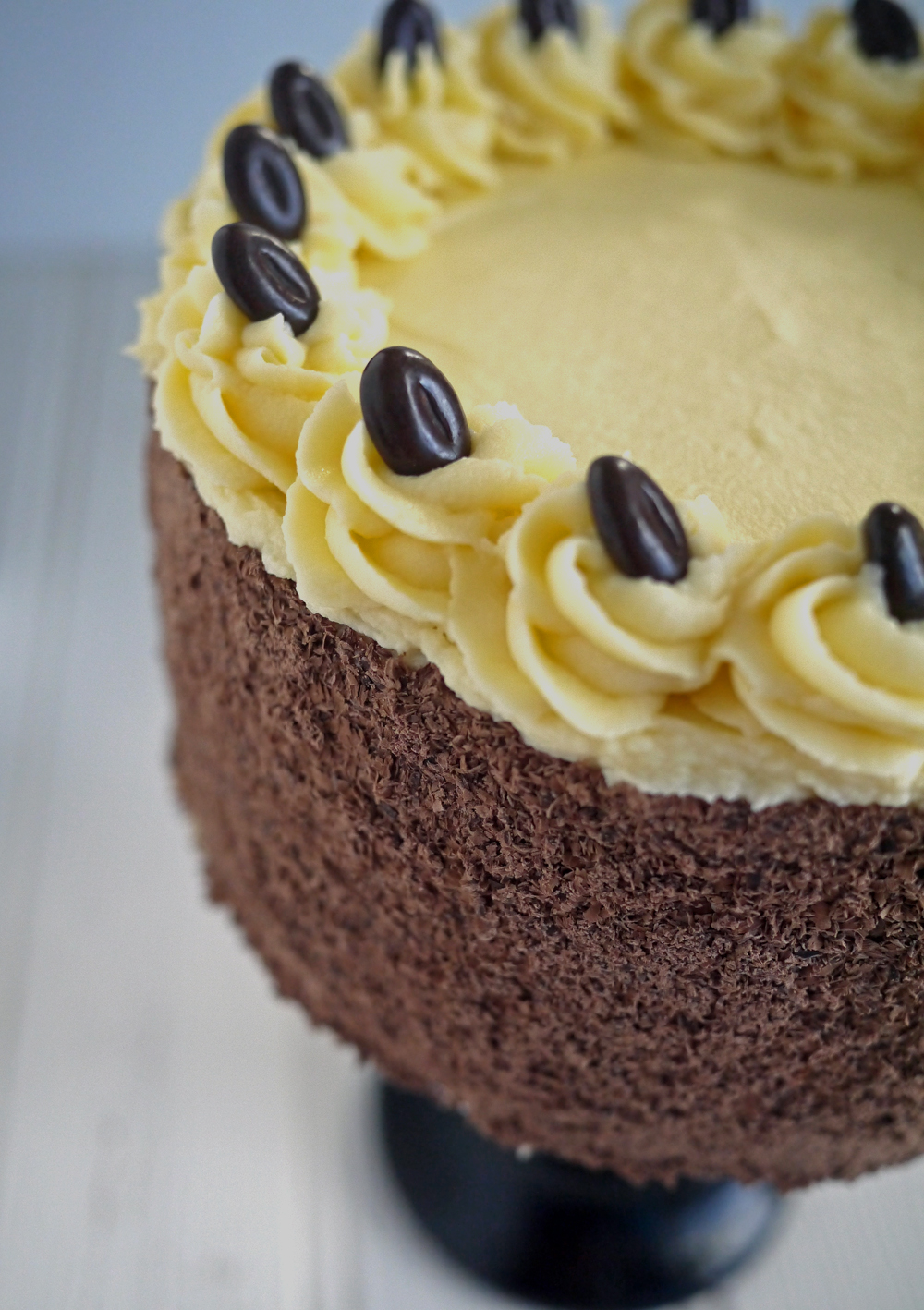 Close up of coffee flavoured buttercream icing decorated with coffee beans
