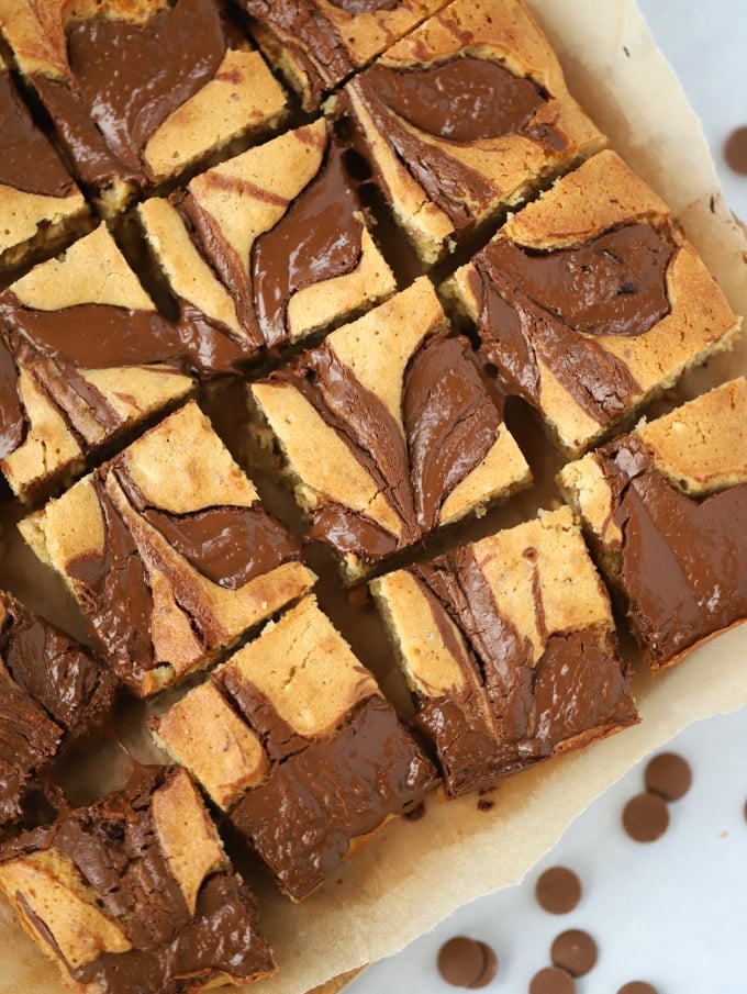 overhead shot of peanut butter blondies swirled with nutella brown paper with a white background