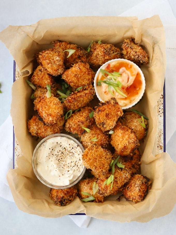 Cooked Homemade Chicken Nuggets with dips in a tray.