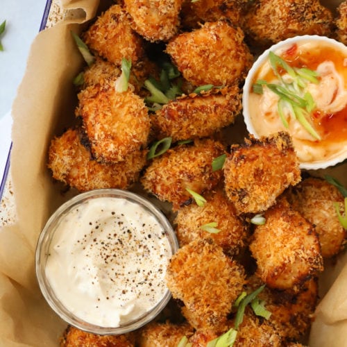 Homemade chicken nuggets coated in breadcrumbs with dipping sauces.