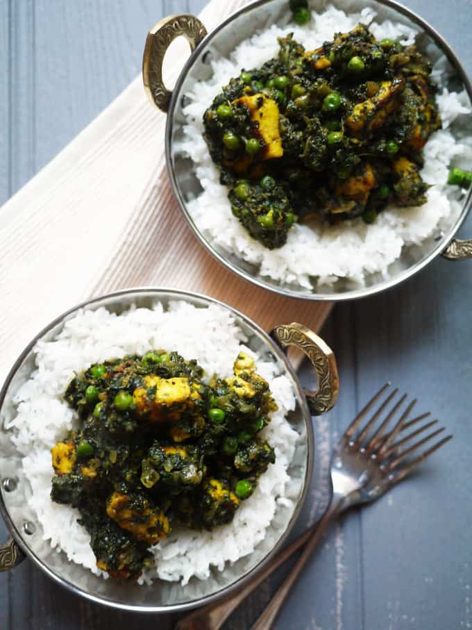 Vegetarian curry Palak Paneer on a table in two bowls with rice.