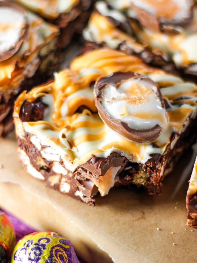 A square of creme egg rocky road with a bite taken out.
