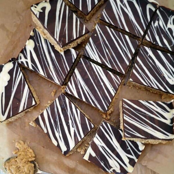 Peanut Butter Crunch Bars - Deliciously, moreish and easy to make tea time treats. Packed with peanut butter and topped with a slab of milk chocolate, these are a must bake! http://www.TamingTwins.com