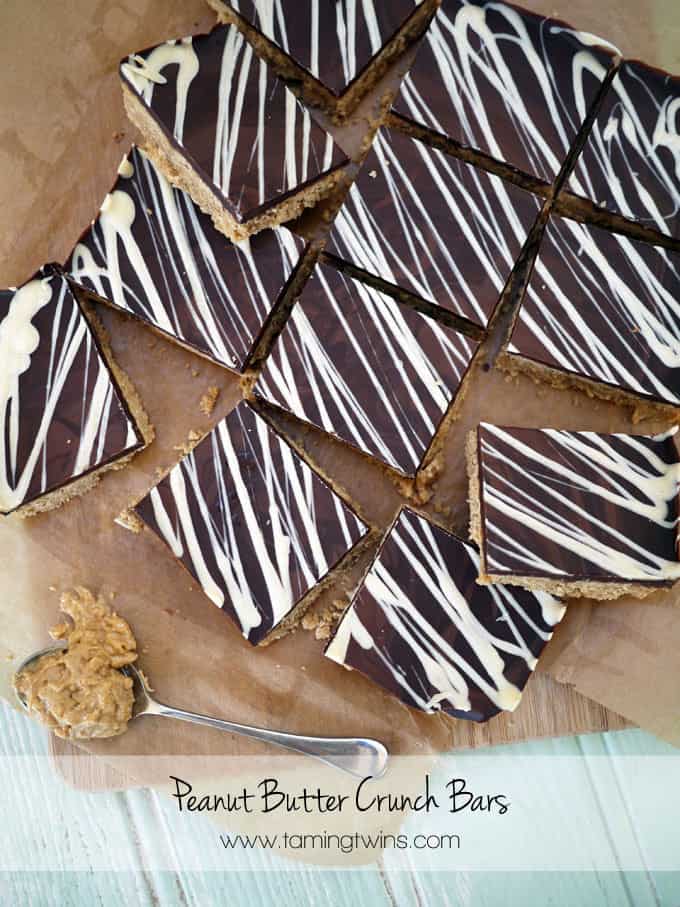 Peanut Butter Crunch Bars - Deliciously, moreish and easy to make tea time treats. Packed with peanut butter and topped with a slab of milk chocolate, these are a must bake! http://www.TamingTwins.com