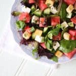 A feta, watermelon and mint salad with baby leaves and rocket. A light and delicious summer salad, with added croutons to make a meal of it. Perfect for an al fresco lunch or dinner. https://www.tamingtwins.com