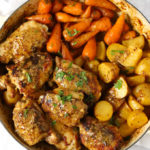 Chicken thighs with honey and mustard sauce with potatoes and carrots