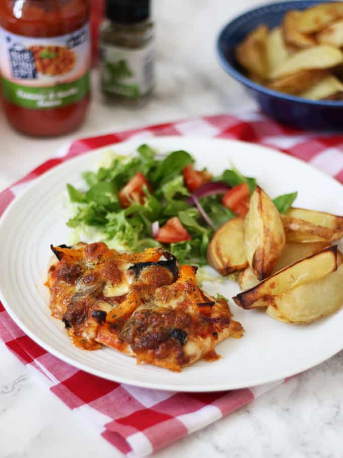 Pizza topped chicken - Chicken breasts topped with pizza toppings and mozzarella cheese, a great higher protein, wheat free, gluten free, alternative to regular pizza. Served with potato wedges and salad for a delicious dinner. 