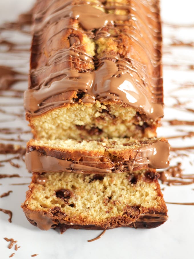 Banana cake drizzled with chocolate and with chocolate chips in.