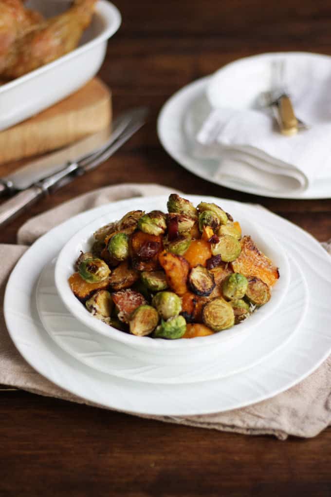 Oven baked Brussels sprouts with with butternut squash, bacon and Parmesan cheese. The best ever Brussels sprouts, oven roasted for the perfect Christmas side dish.