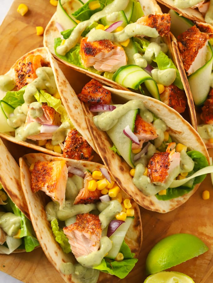 Salmon tacos with lime, lettuce, corn and avocado dressing