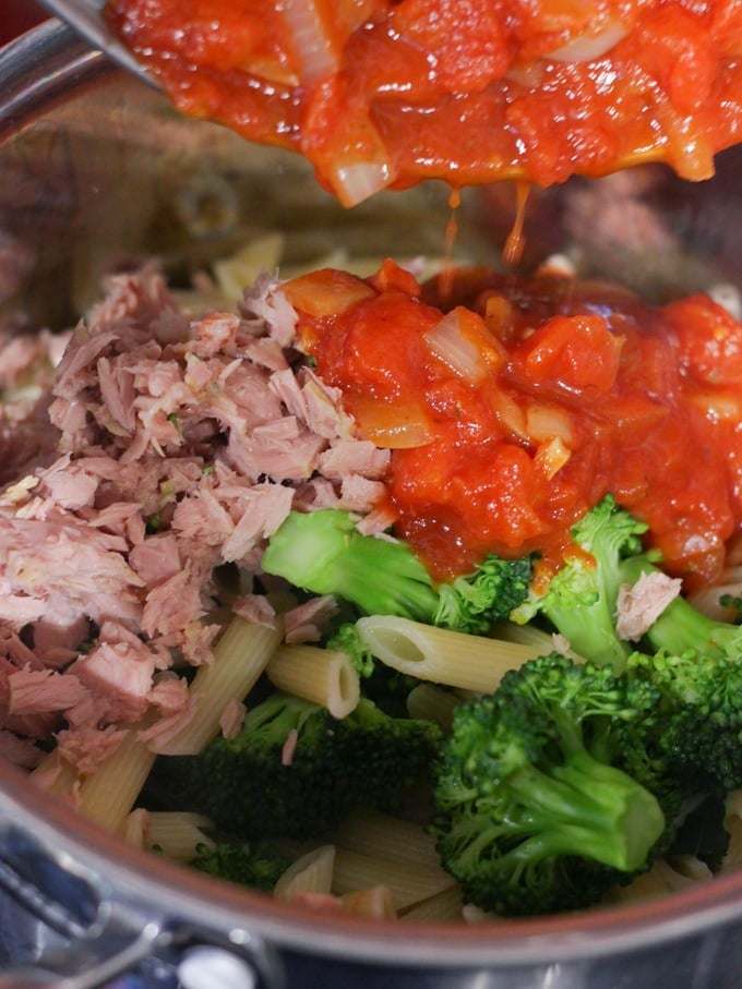 pasta, broccoli, homemade tomato sauce and fish in a saucepan