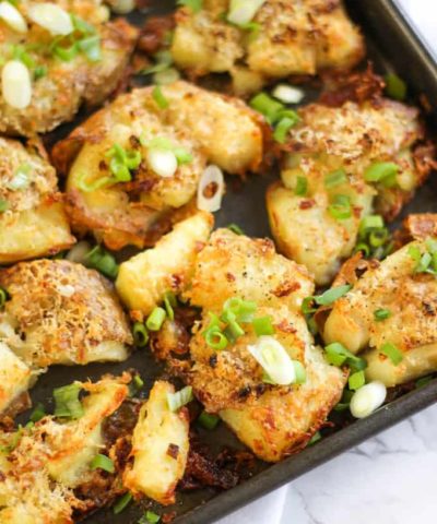 Garlic Parmesan Crushed Potatoes - Crunchy, crispy, crushed new potatoes, smothered in garlic and Parmesan cheese. The ultimate accompaniment side dish.