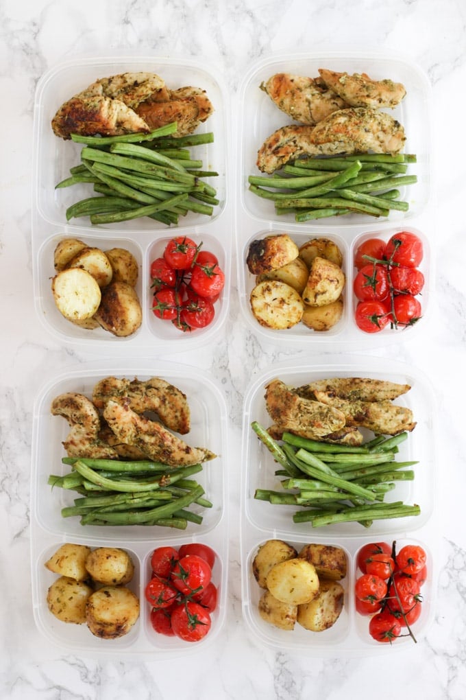 Pesto Chicken meal prep in plastic compartment tubs