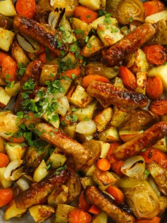 Simple sausage tray bake with carrots potatoes and leeks, all on one tray.