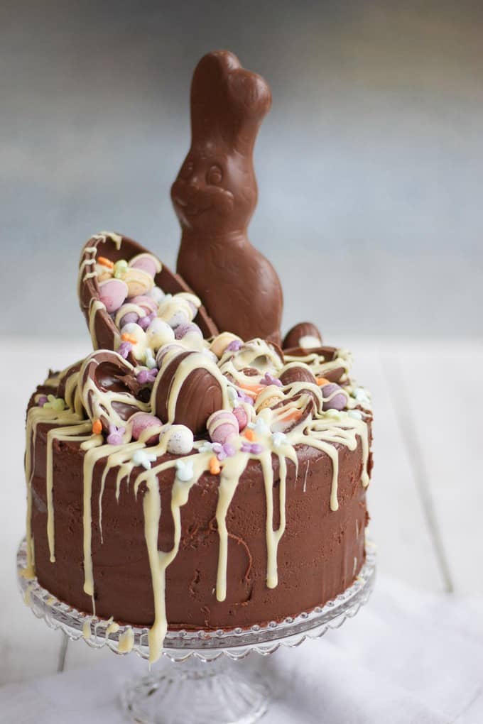 The Ultimate Easter Chocolate Cake! Overload on Easter treats in this decadent, delicious and rich Easter chocolate cake. Topped with Cadbury's Creme Eggs, Mini Eggs, white chocolate drizzle, bunnies and Caramel Eggs. What more could you need in an Easter dessert?!