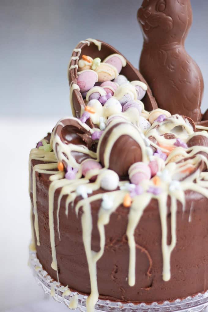 The Ultimate Easter Chocolate Cake! Overload on Easter treats in this decadent, delicious and rich Easter chocolate cake. Topped with Cadbury's Creme Eggs, Mini Eggs, white chocolate drizzle, bunnies and Caramel Eggs. What more could you need in an Easter dessert?!