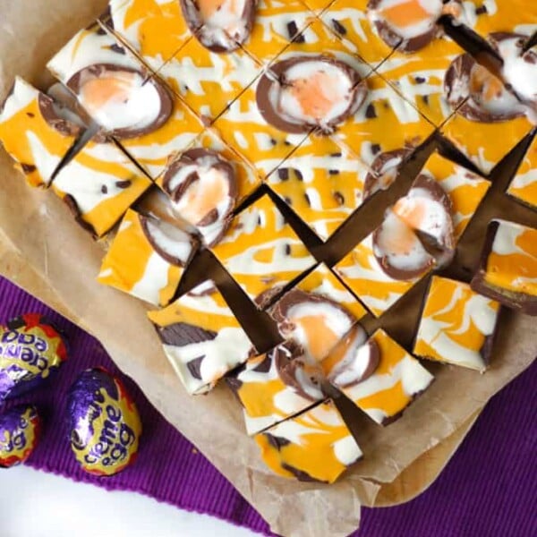 Overhead photo of yellow drizzled Creme Egg chocolate fudge cut into small squares.