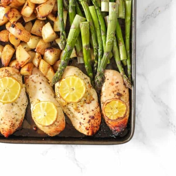 This One Pan Lemon Asparagus Chicken recipe is a quick and simple dinner using chicken breasts, roasted with potatoes, asparagus, lemon and honey. A really easy family meal.