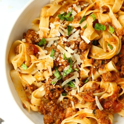Bowl of spaghetti bolognese with parmesan and basil