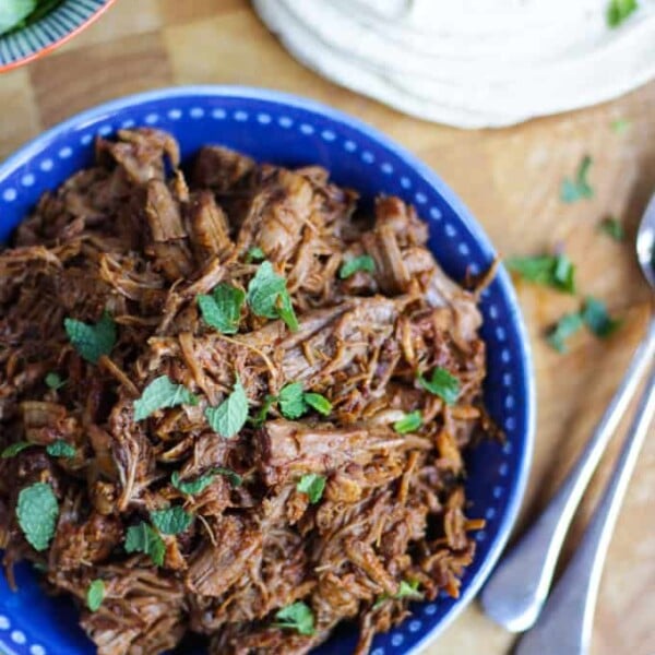 Overhead shot of instant pot pulled pork recipe sprinkled with mint.