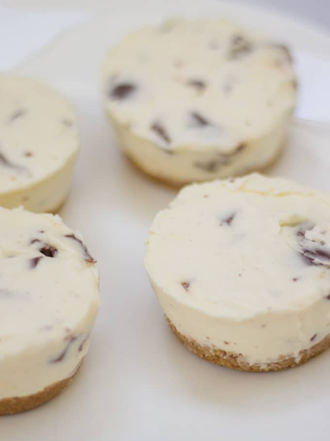 Mini cheesecakes on a white plate.