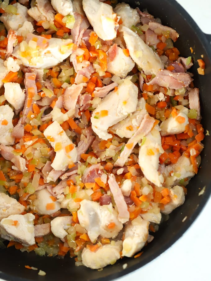 Chicken and vegetables frying in a pan