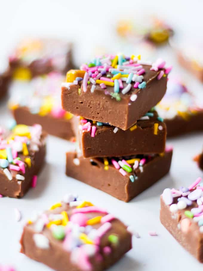 Stack of cubes of microwave fudge with sprinkles.