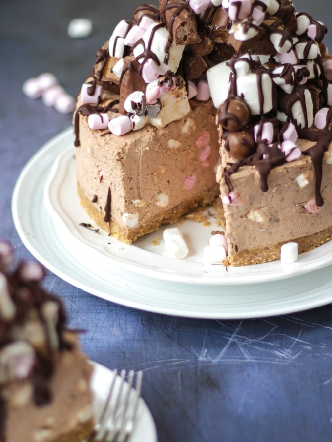 Rocky Road Cheesecake with a slice cut out showing pink and white mini marshmallows inside and on top.