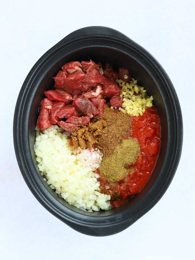 Raw ingredients ready to be cooked with meat tomatoes and spices