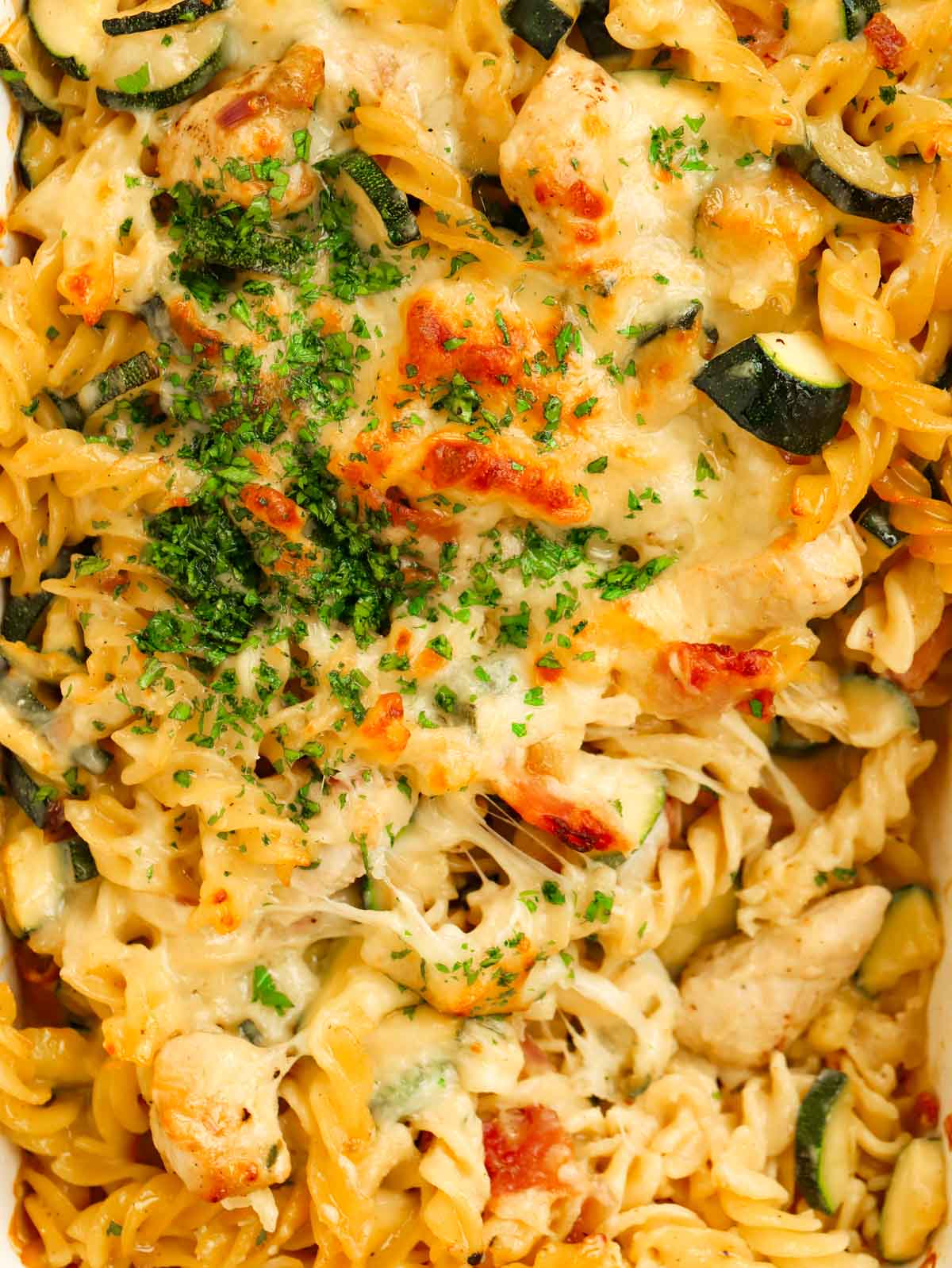 Close up of chicken and bacon pasta bake dish