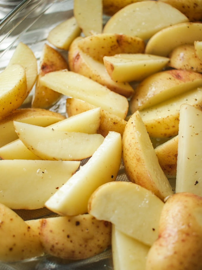 Close up of potato wedges uncooked. How to make easy peasy Homemade Fish Fingers using our simple recipe. Just four ingredients and supper tasty family meal every time. 