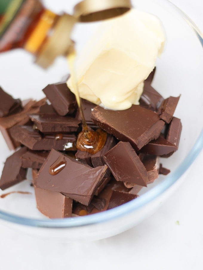 Chocolate, golden syrup and butter in a bowl for Malteser Rocky Road Cake.