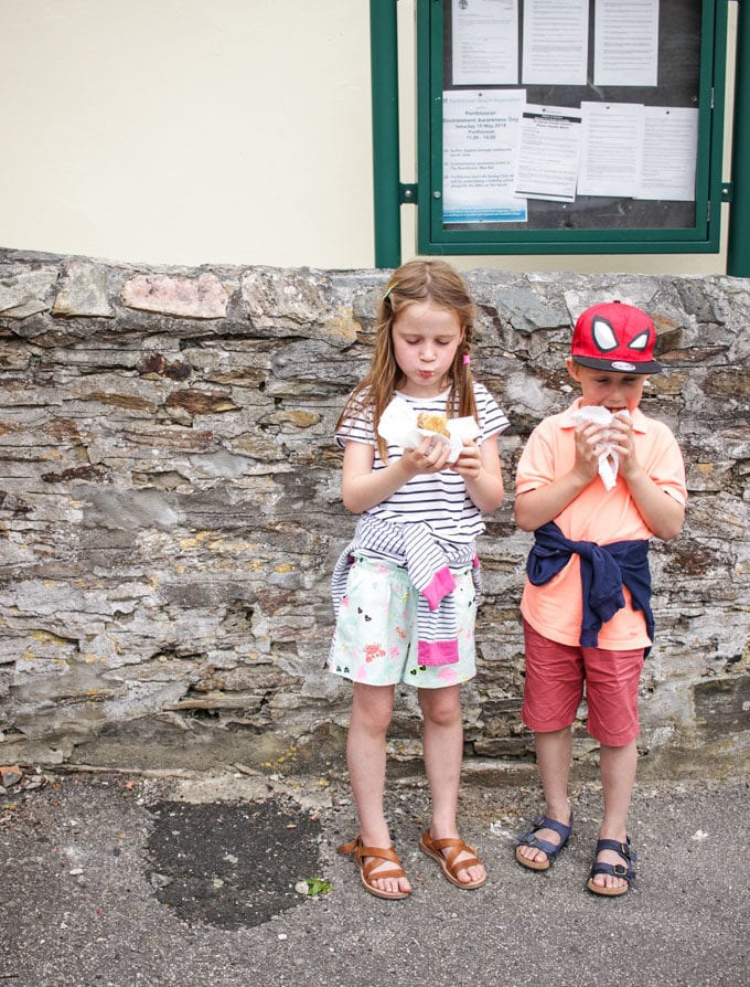 Girl and boy eating traditional Cornish pasties in St Agnes in St Trevicks Pasties - Perran Sands Holiday Park from Haven. Top 5 foodie things to do in and around Perranporth, Cornwall. If you're staying at Haven, Perran Sands, here are some recommendations for the best food, restaurants and places to eat nearby.