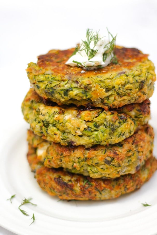 Easy Courgette Fritters Recipe - Oven Baked with Feta Cheese - These healthy and simple Courgette Fritters (or Zucchini Fritters) are perfect for all the family. Made with feta cheese, and baked in the oven, they are a delicious fresh dinner. #courgettefritters #vegetarian #vegetarianmeals #zucchini #zucchinifritters #tamingtwins