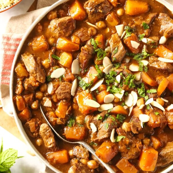 Easy lamb tagine in a dish with spoon, sprinkled with almonds and mint