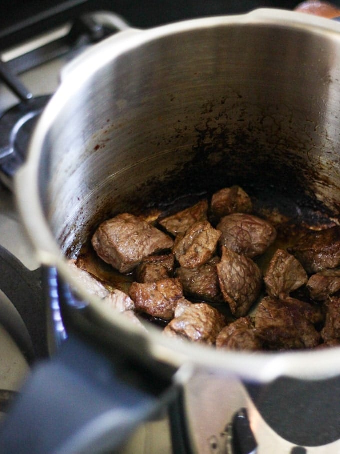 Photo of beef pieces browning in Prestige pressure cooker.