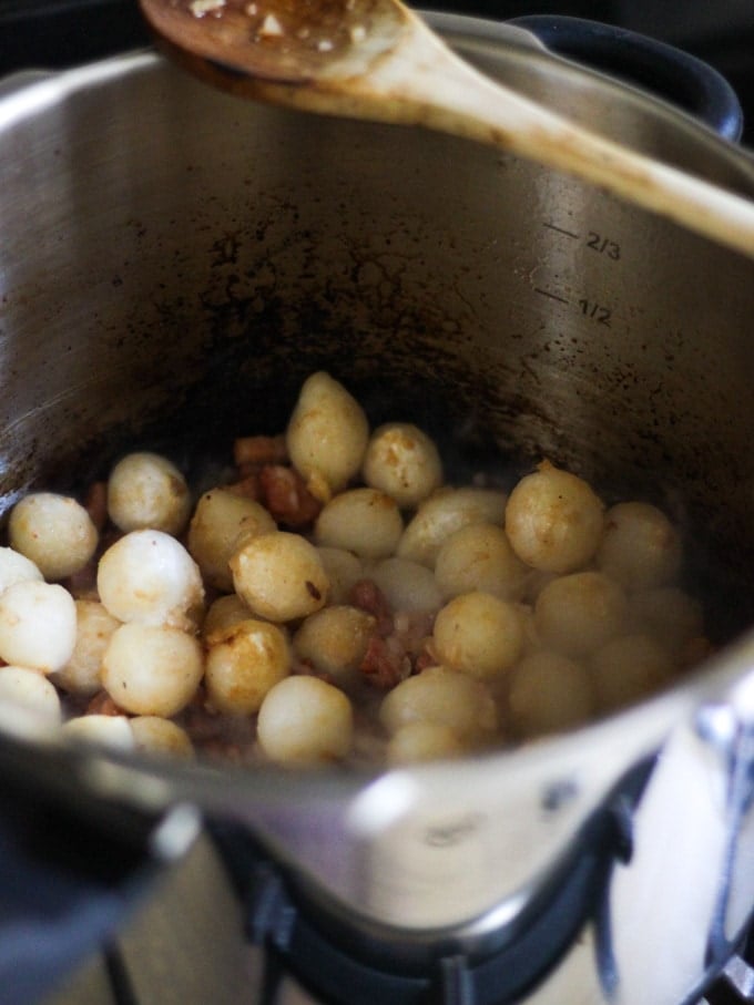 Photo of pearl onions (or shallots) browning in Prestige pressure cooker.