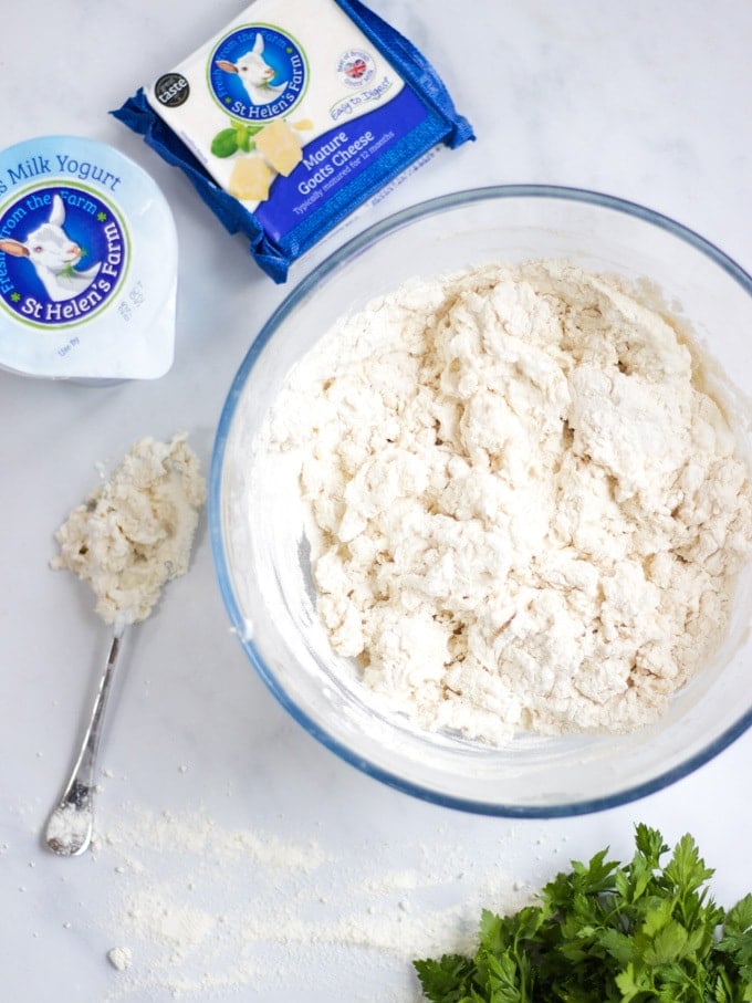 Overhead photo of a bowl of easy flatbread dough, goats milk yoghurt and goats cheese.