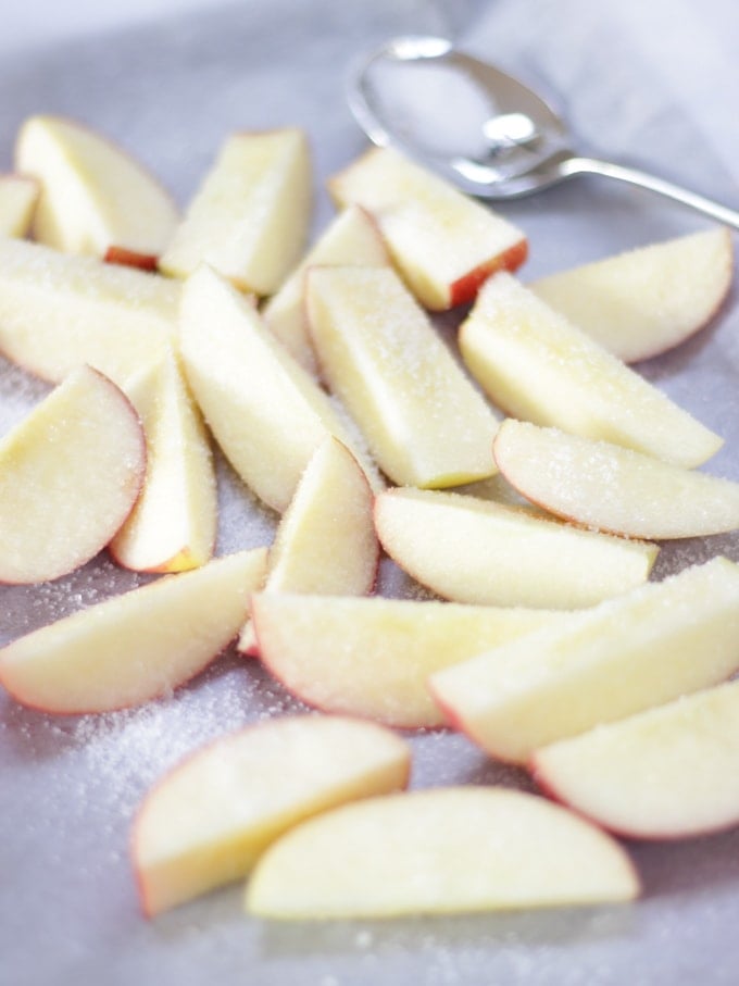 Chopped apples sprinkled with sugar for how to make a pavlova blog post.