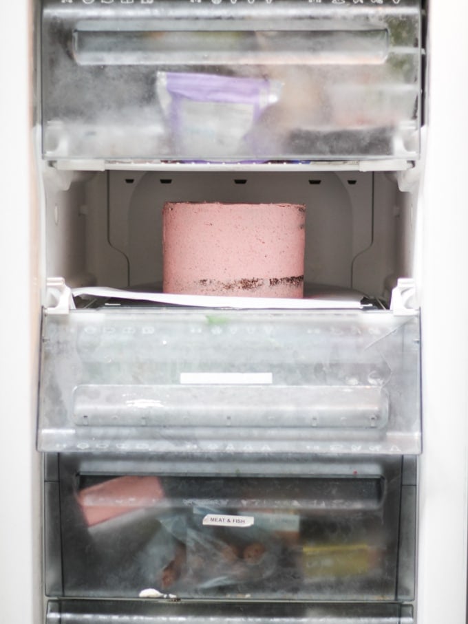 Raspberry cake in the freezer having been crumb coated.