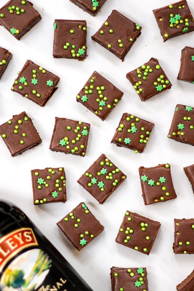Overhead photo of bottle of baileys in the corner and cubes of Baileys easy microwave fudge.