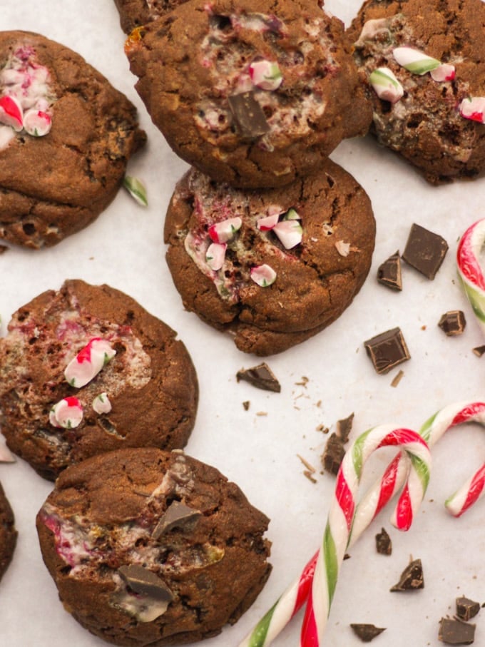 Candy cane cookies on white marble background with chocolate.