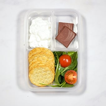 Healthy lunch box idea, cottage cheese, crackers and spinach