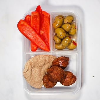 lunchbox with compartments filled with falafel, healthy lunch idea for work