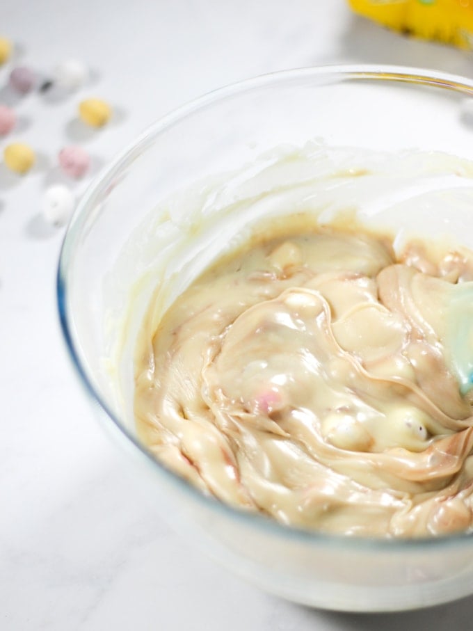 Mini Egg fudge mixture in a glass bowl, not set.