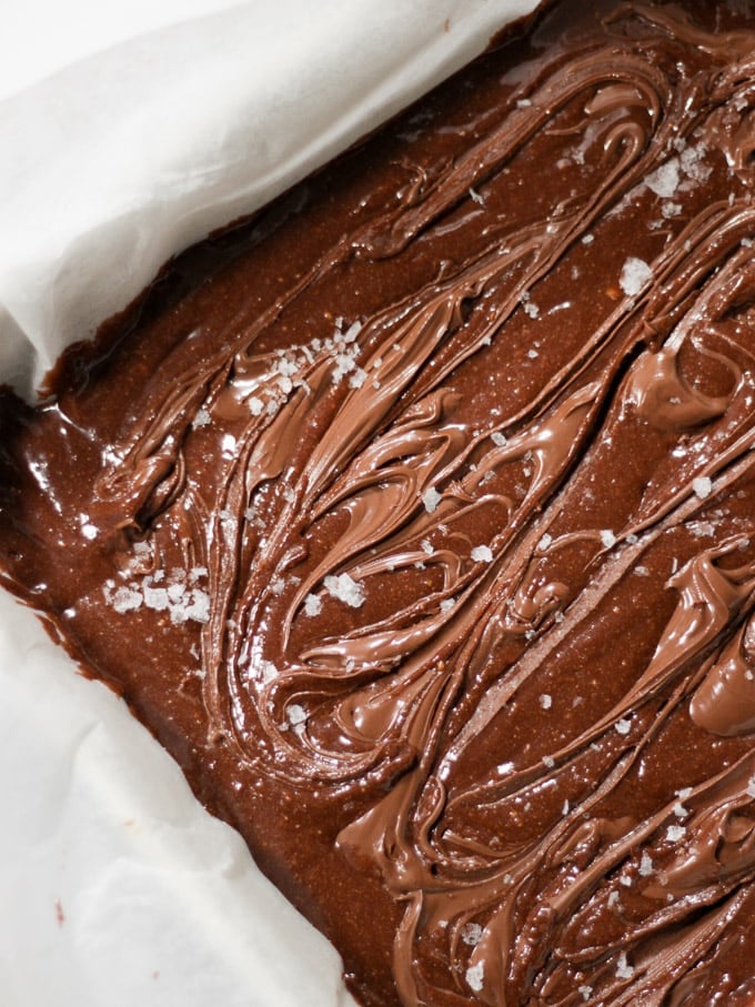 uncooked Nutella brownies in baking dish swirled on top 