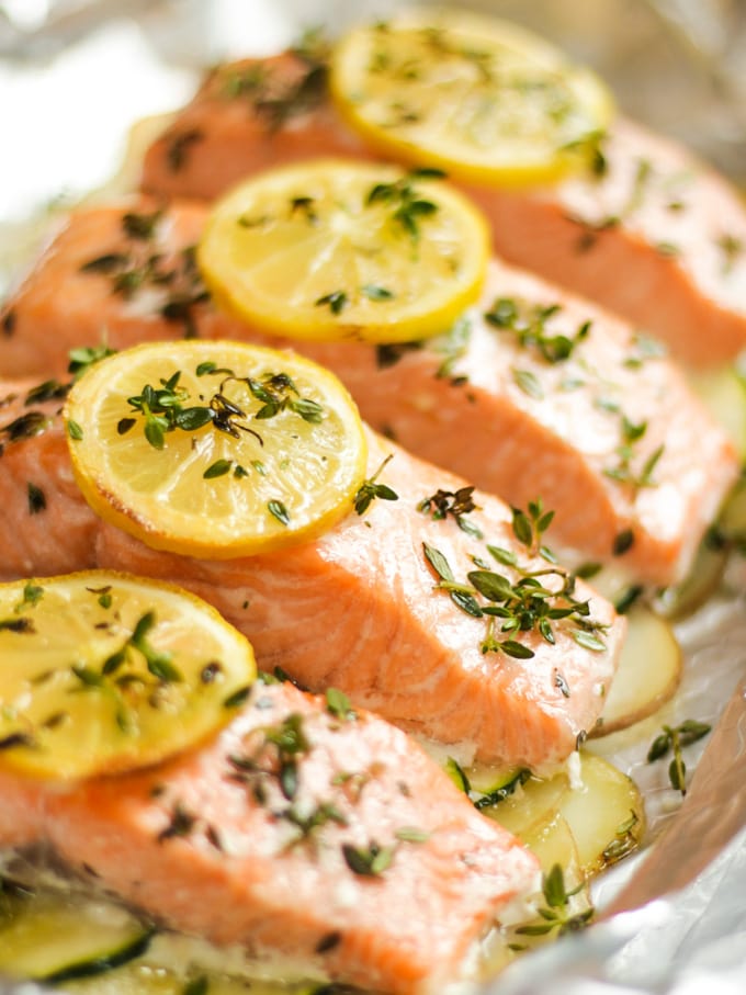 Fish fillets cooked in foil with potatoes lemon and thyme.