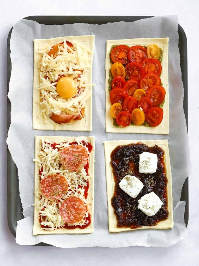 Raw uncooked puff pastry tart with a variety of toppings