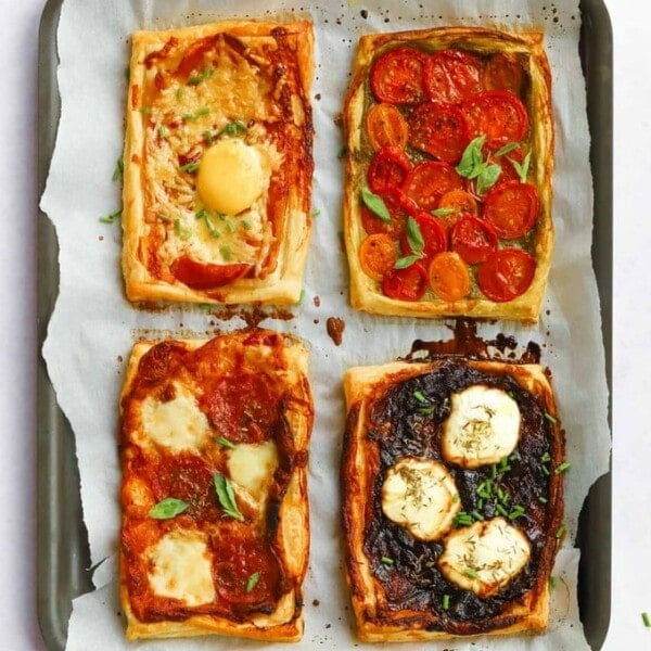Easy puff pastry tarts with tomatoes, cheese, goats cheese, caramelised onions and bacon
