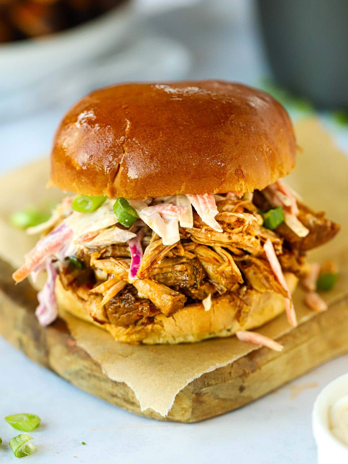 Slow Cooker Pulled Pork served in a bread bun with coleslaw
